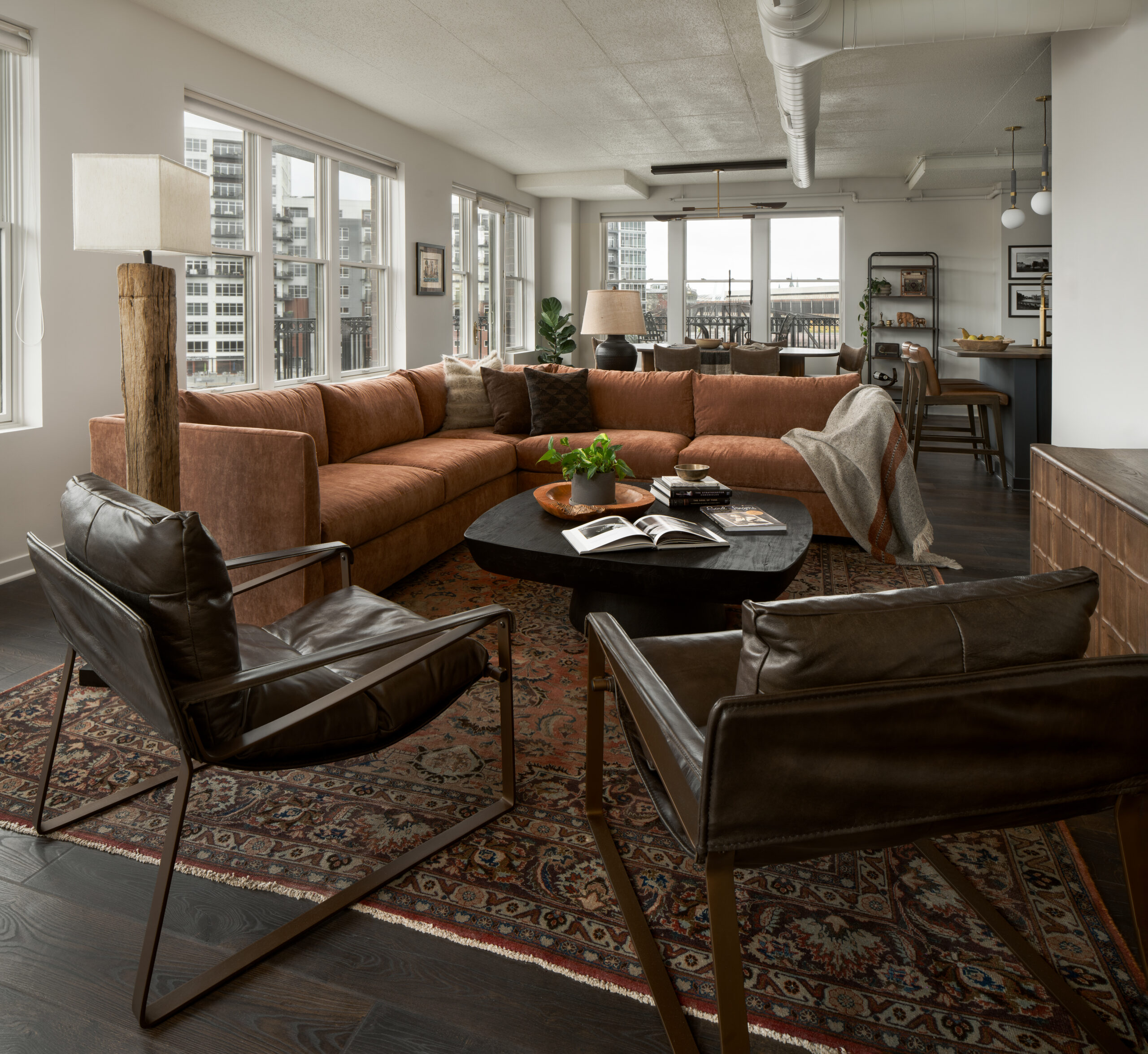 A rustic, contemporary living room featuring a warm color palette and layered look.