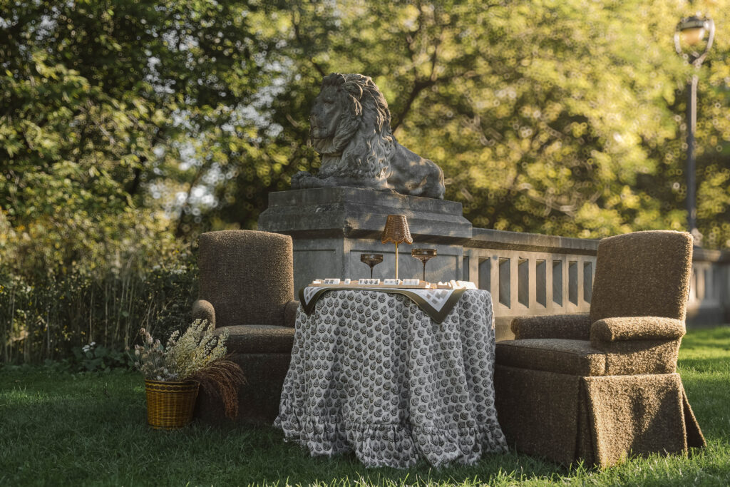 Two custom Taylor King captain's chairs are arranged at a parlor table covered in a custom Stone House Made tablecloth, set for a Mahjong match.