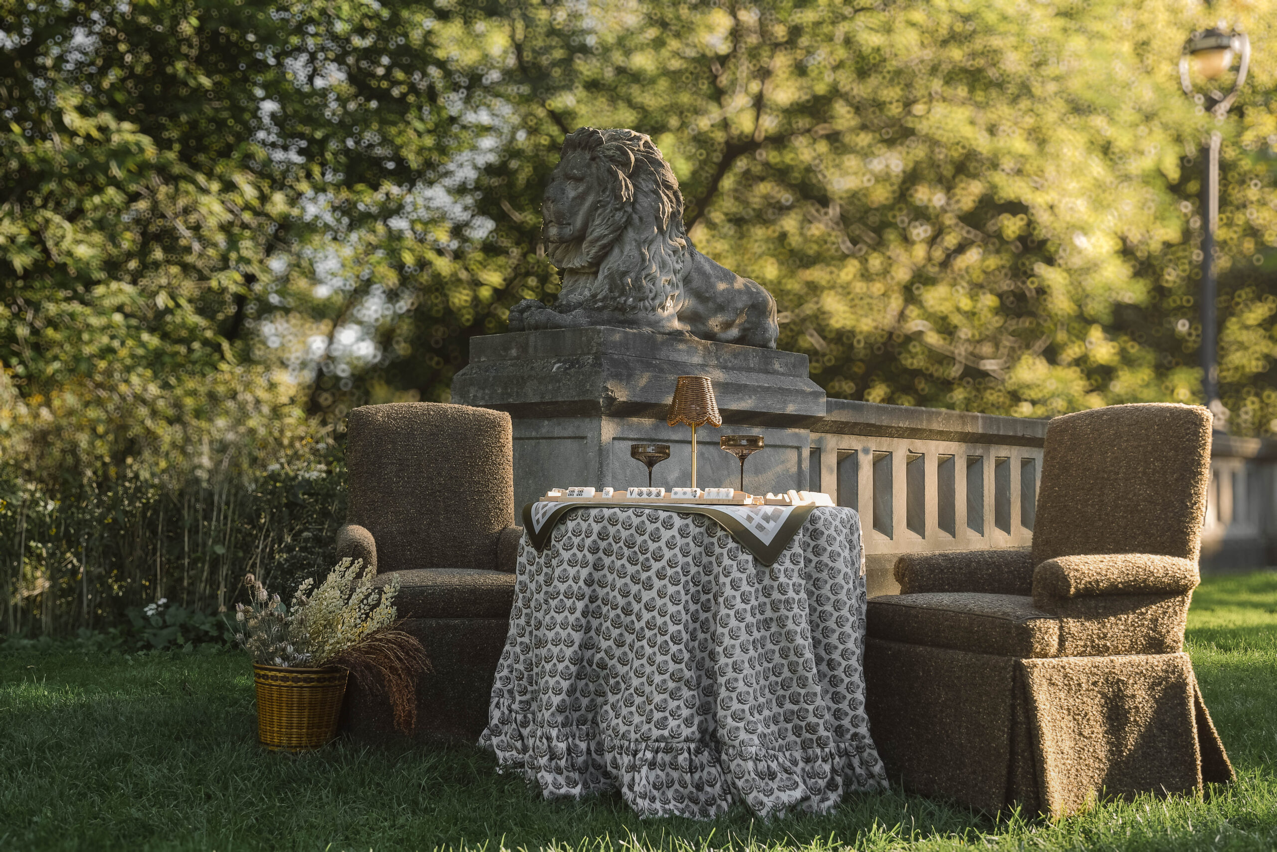 Parlor table set for Mahjong with a Stone House Made tablecloth and two textured armchairs, from the Art of Gathering campaign by Stone House Collective, a furniture store in Milwaukee